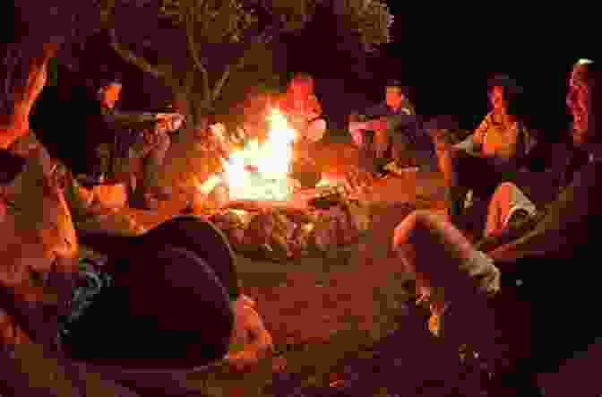A Group Of People Sharing Food And Laughter Around A Campfire The Ultimate How To Live Off The Grid: Off Grid Living To Learn How To Go Off The Grid Surviving Off Grid And To Know Off The Grid Living Equipment You Need Living Off The Land Survival